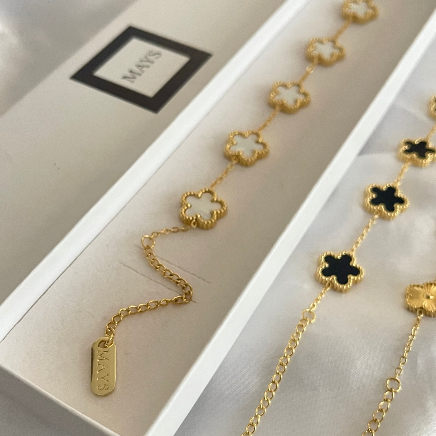 Gold white clover bracelet in a branded box